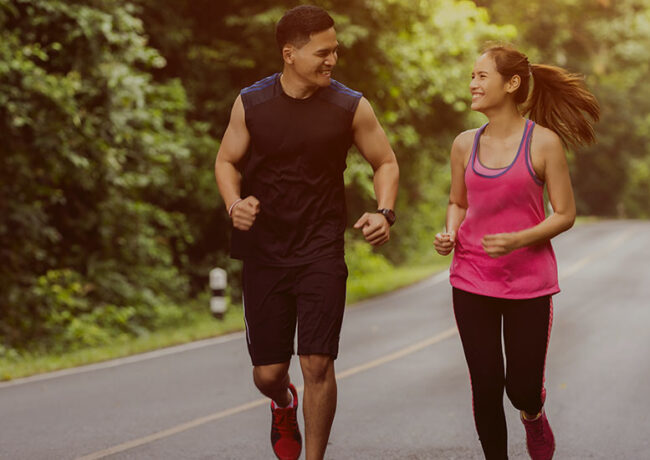 woman and man running on the road