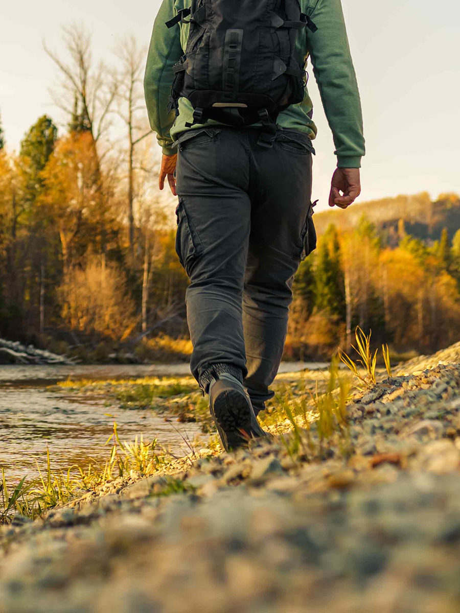 A man hiking by a river