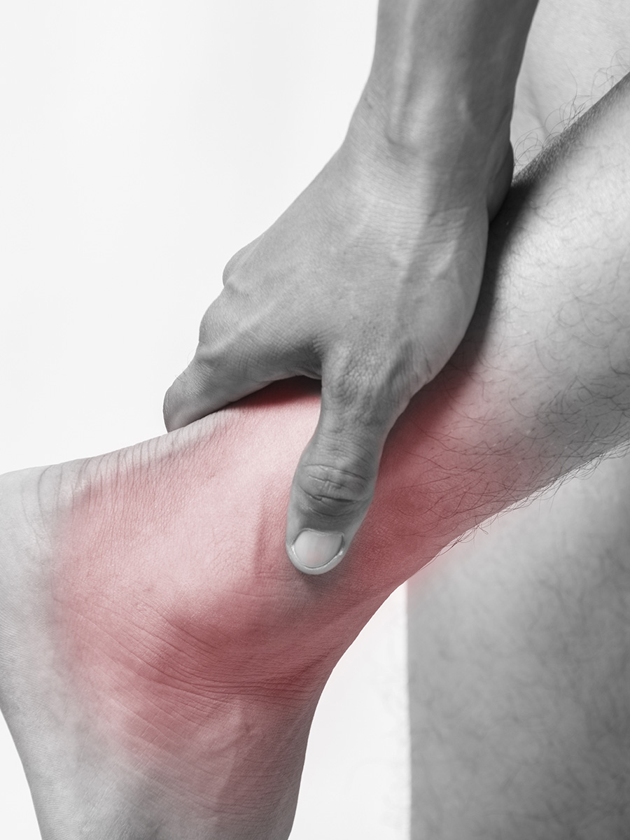 A man holding his ankle in pain