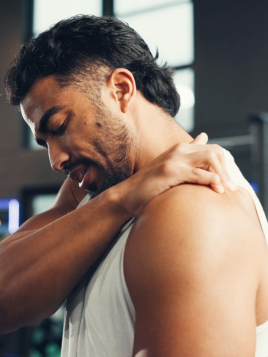 Man rubbing his shoulder in pain