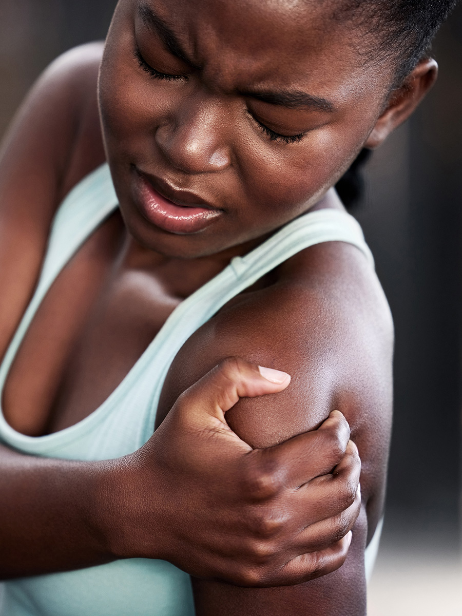 Woman holding her shoulder