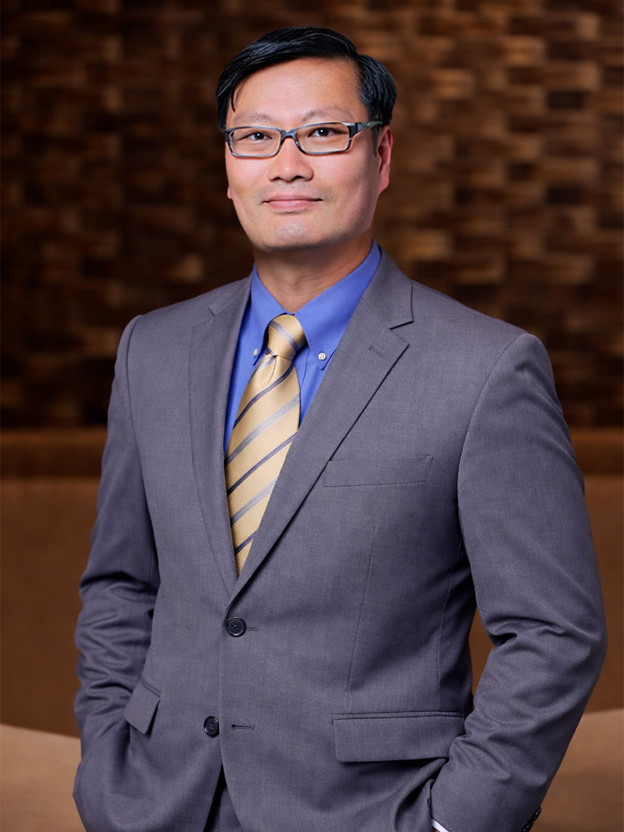 Dr. Chon in a gray suit