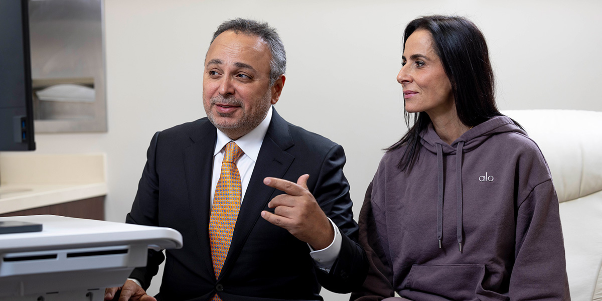 Dr. K reviewing something with a patient on a computer