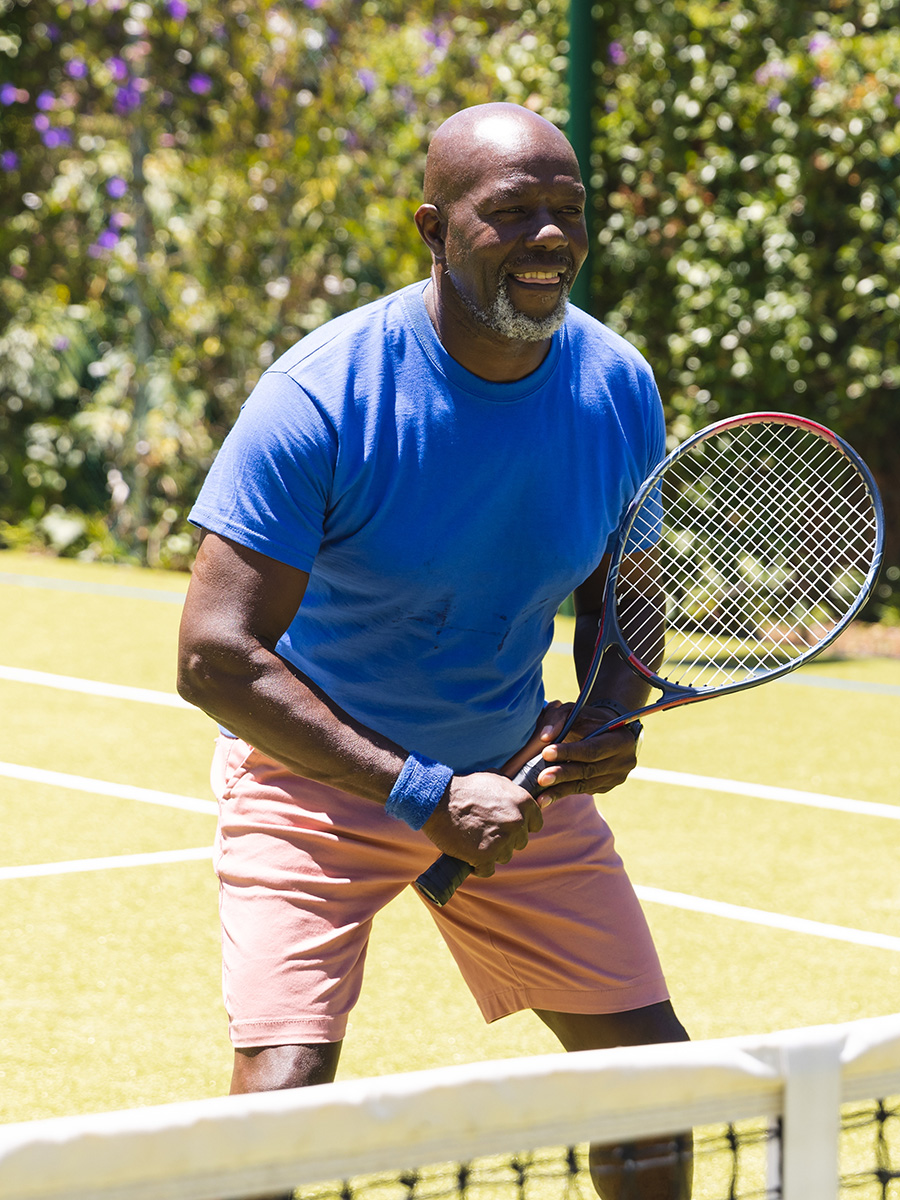 A man playing tennis outdoors