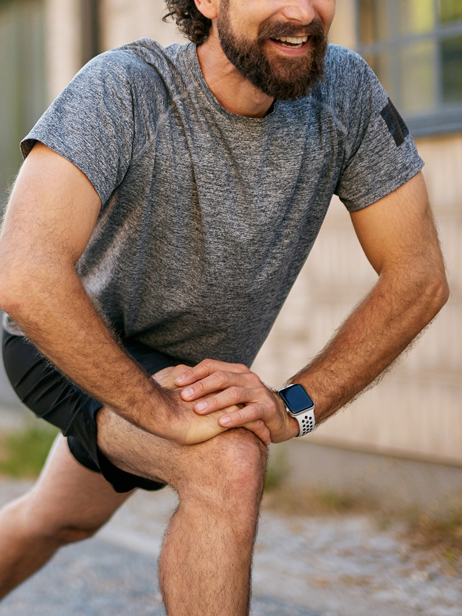 Man in a gray shirt stretching