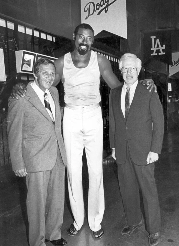 Two doctors with a basketball player