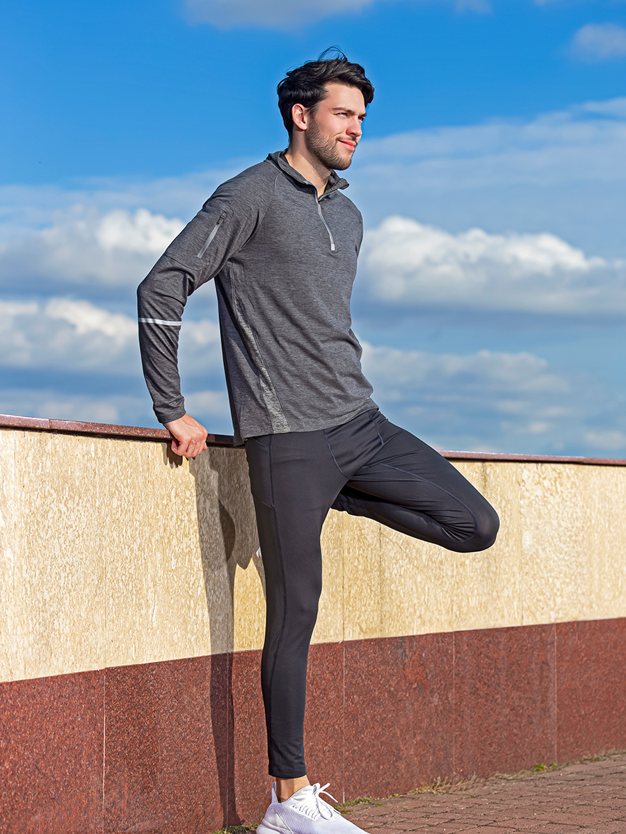 Man leaning against the wall stretching