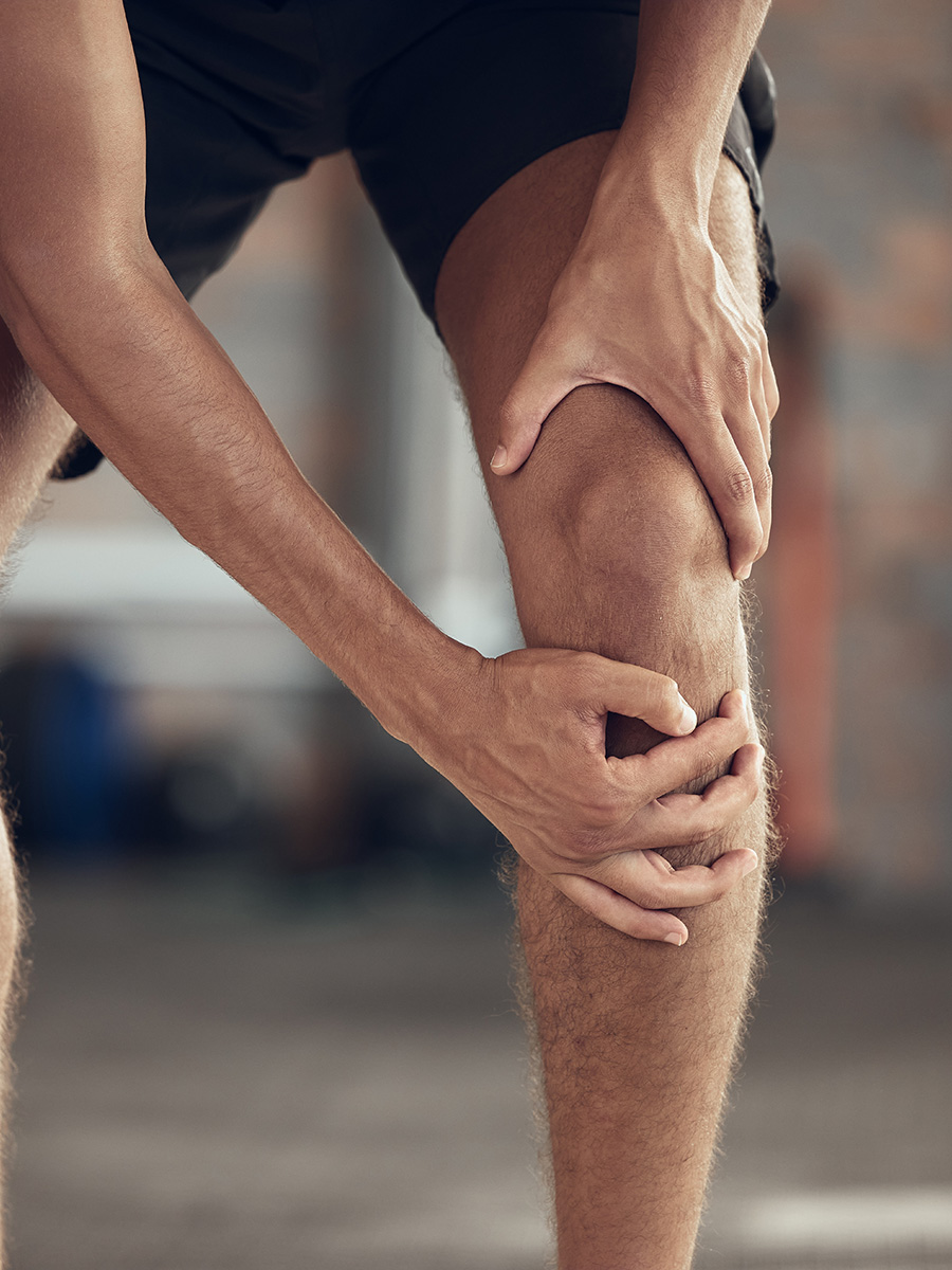 Person leaning over with knee pain