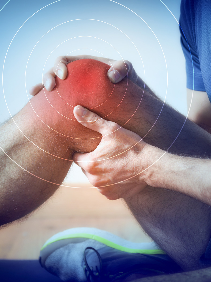 Person sitting on the ground with knee pain