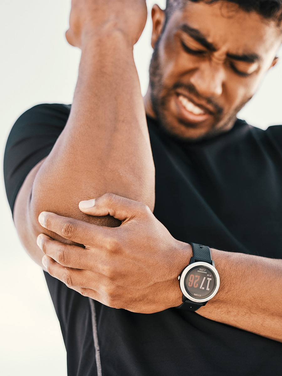 A man holding his elbow in pain