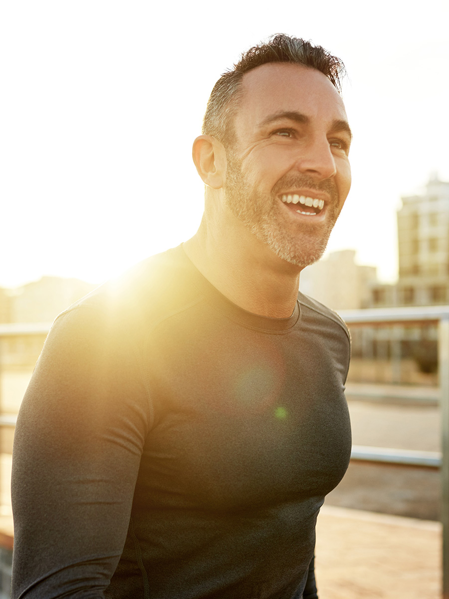 Fit man running at sunset