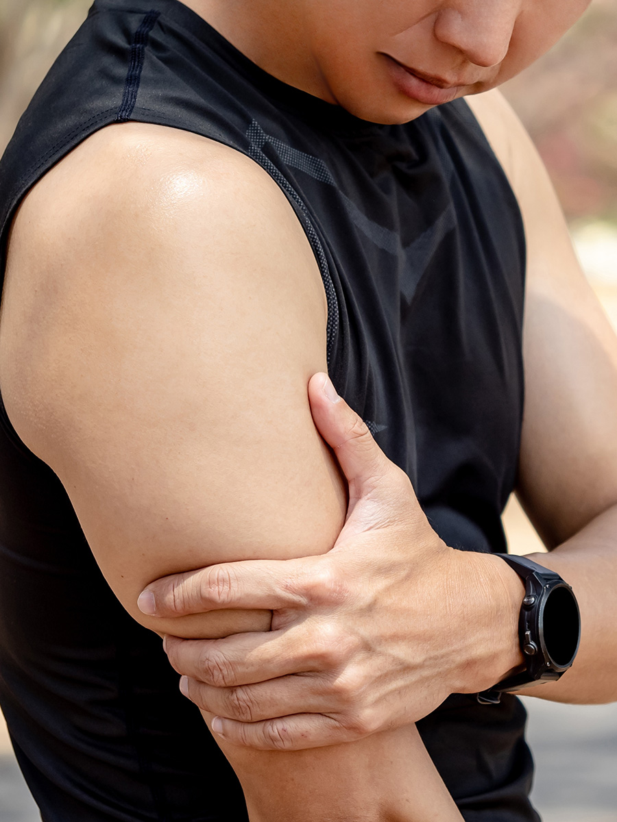 A man holding his tricep in pain
