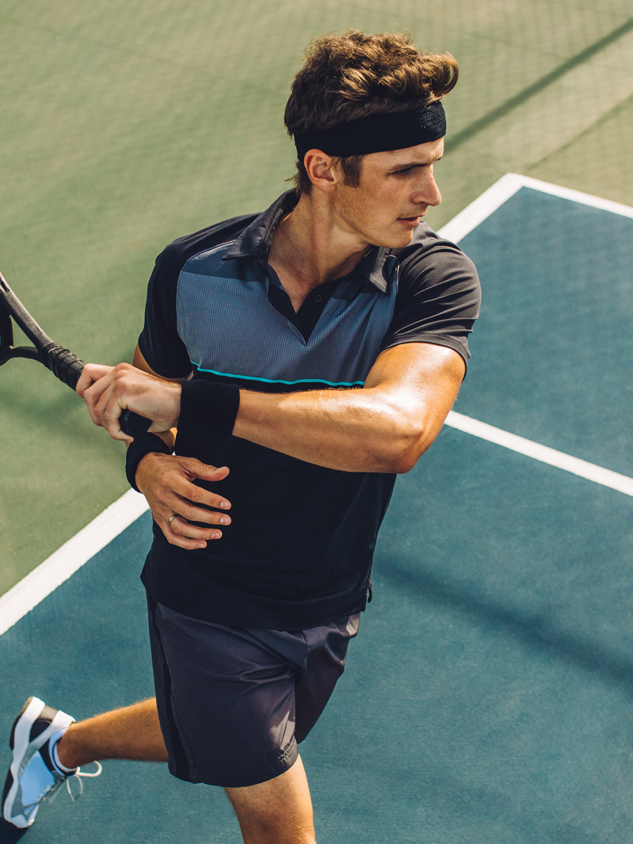 Man outdoors playing tennis