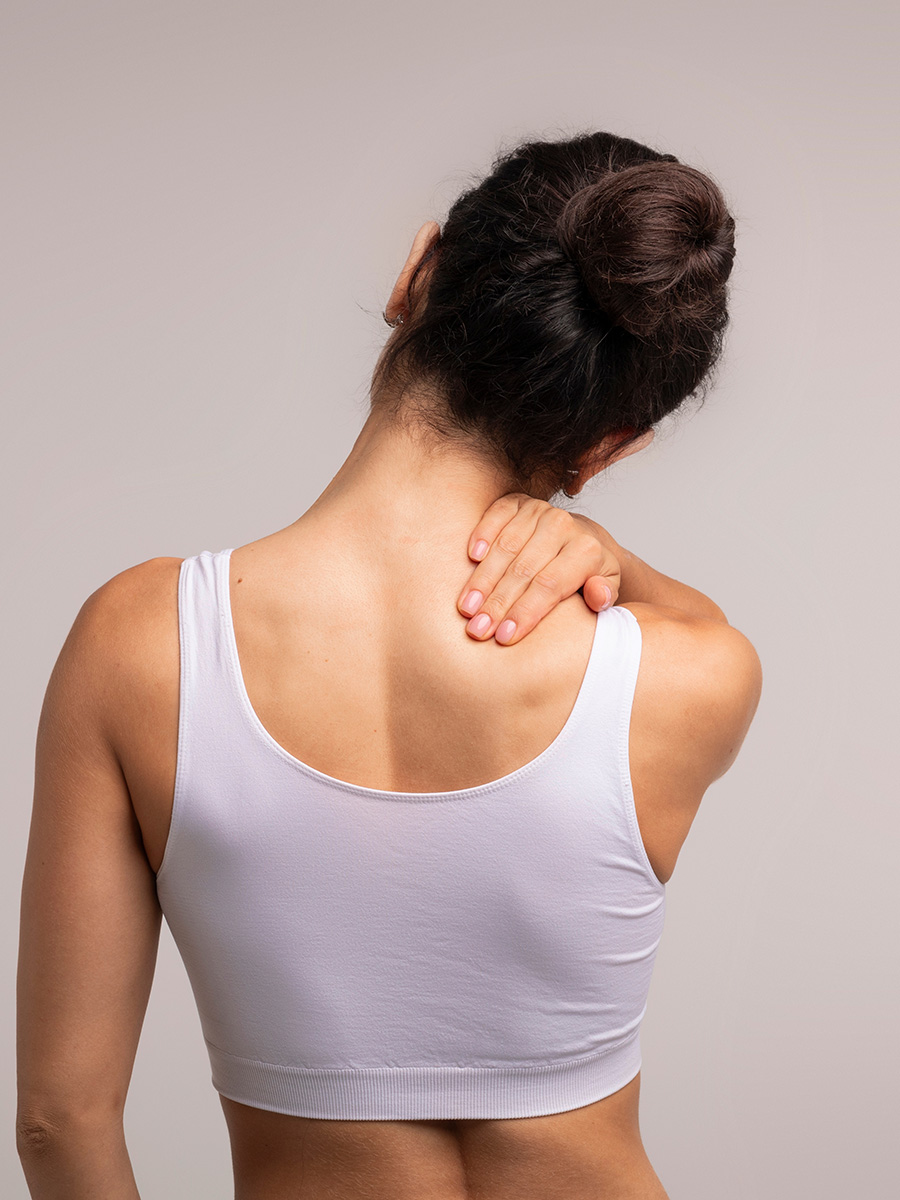 woman rubbing the back of her neck