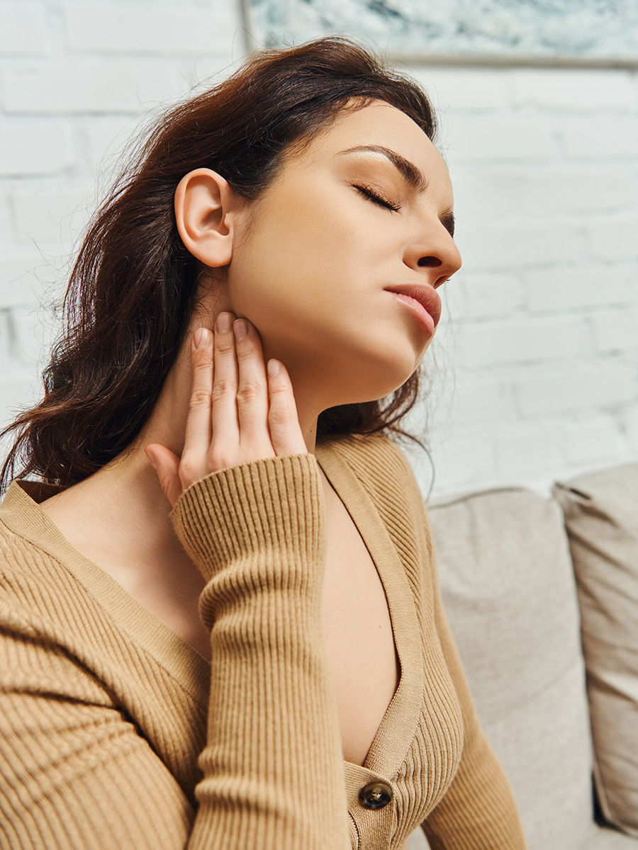 woman rubbing her neck