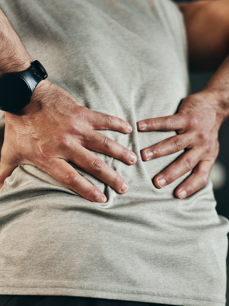 A man holding his lower back in pain