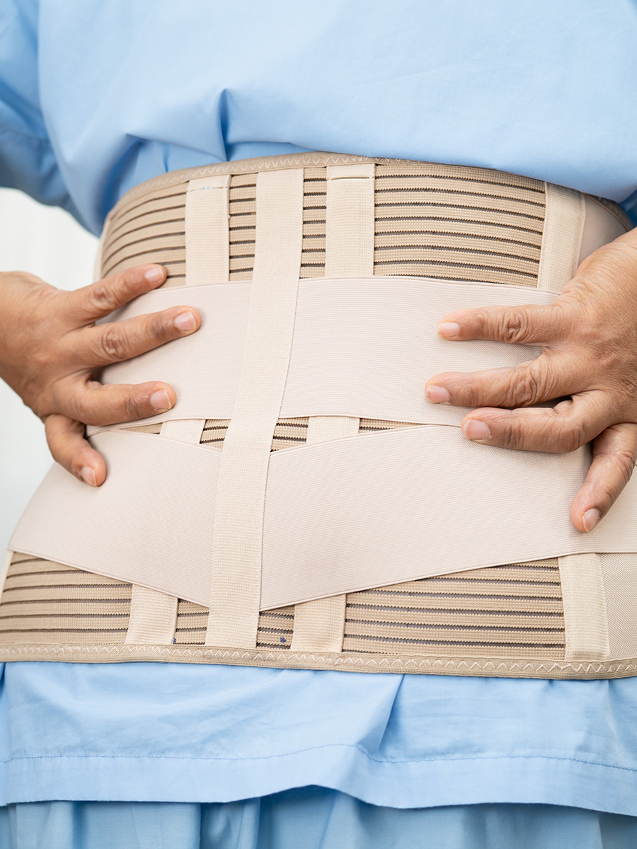 Woman wearing a tan back brace