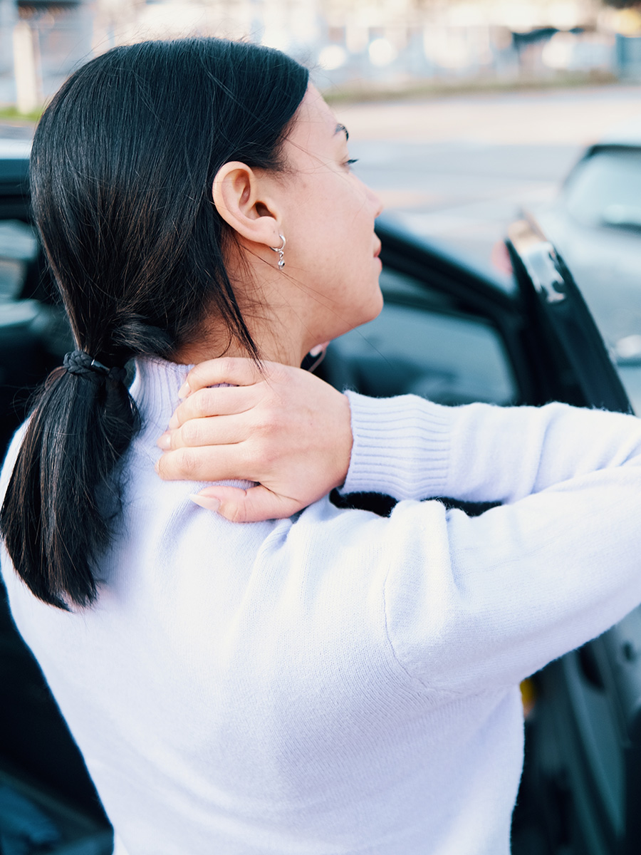 A woman holding her neck after an auto accident