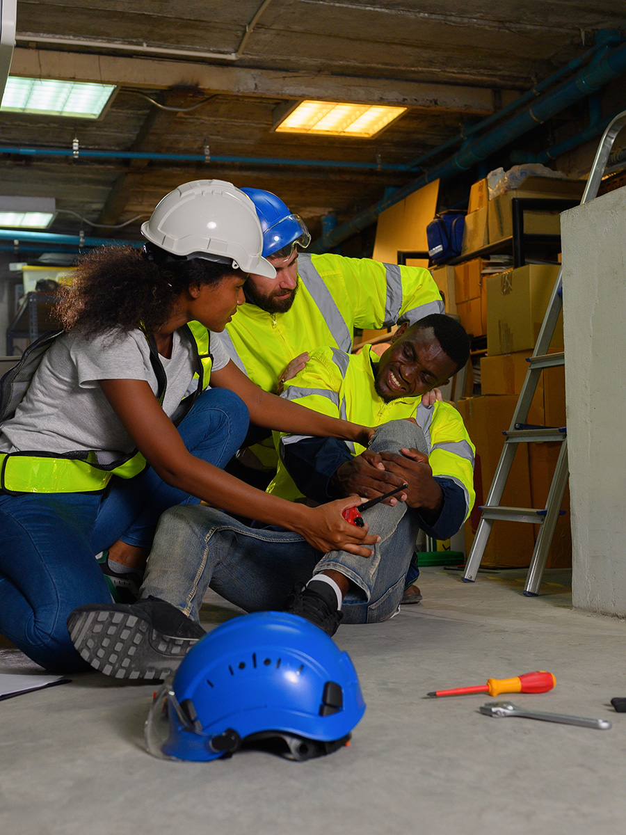 A worker holding his knee in pain
